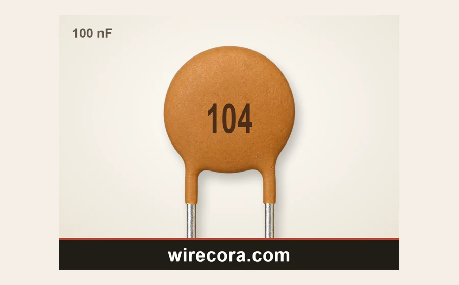 An orange ceramic disc capacitor printed 104, which is 100 nF